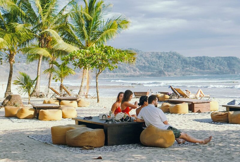 Beachfront bar with craft cocktails — welcome happy hour