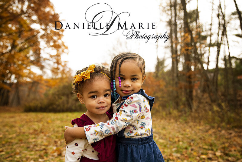 Two little girls hugging during their fall family session in Morris County