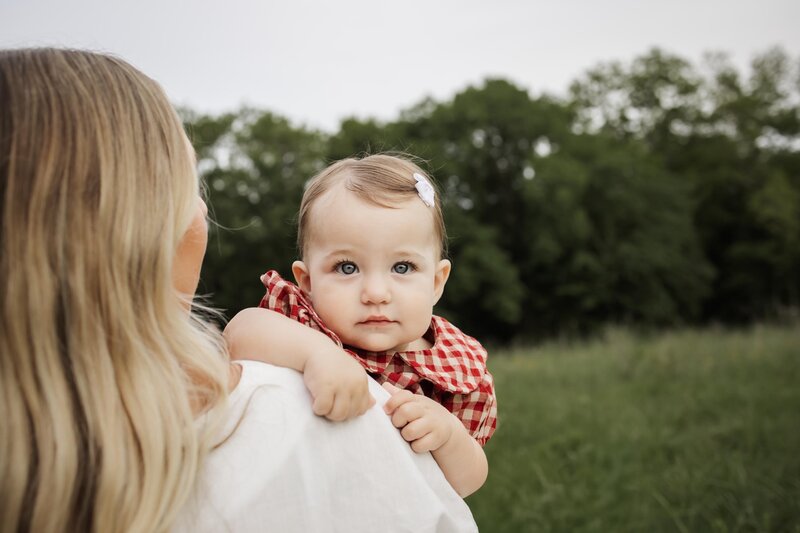 mom embraces infant daughter at a session in Southlake texas