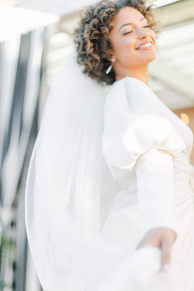 Bride smiling while spinning in white dress