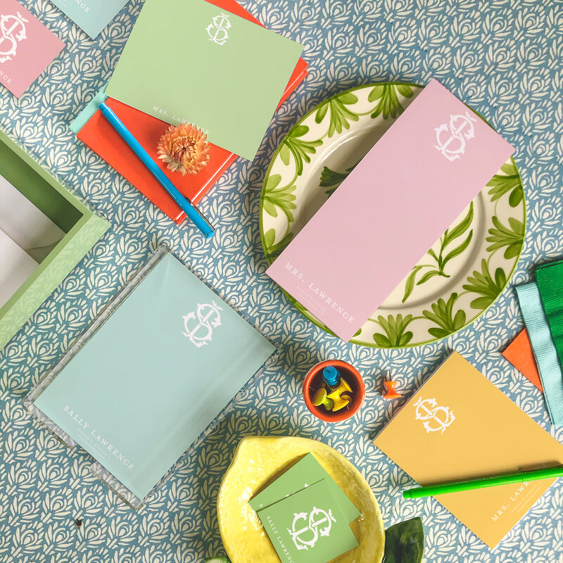 Flat lay photo of colorful stationery sets on top of blue pattern background