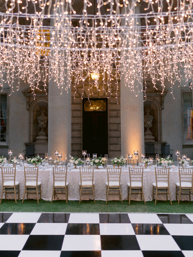 reception with black and white dance floor and string lights