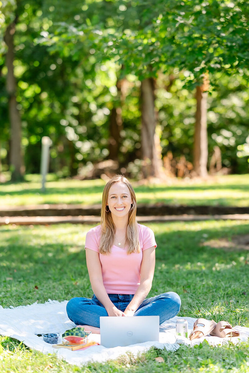 Virtual assistant looks at iPhone while carrying computer