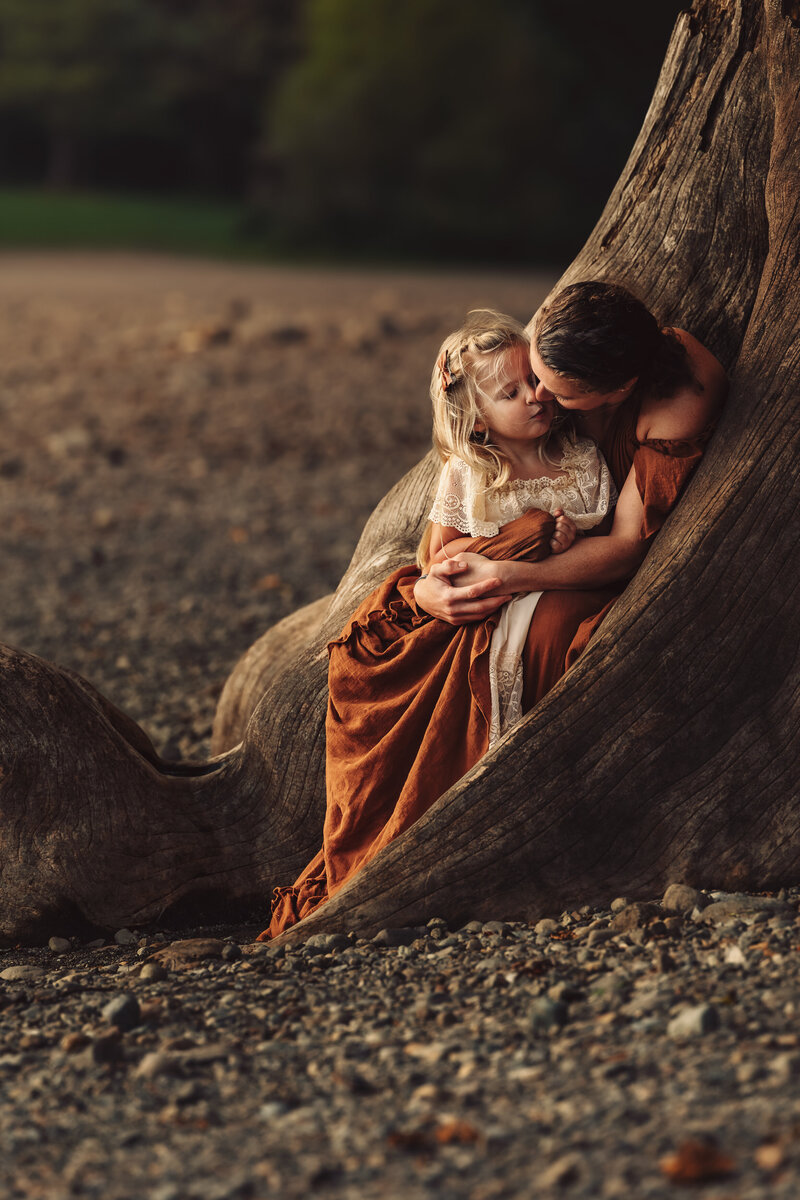 Emotive sunset lifestyle image of mother and daughter at Rattlesnake Lake in Washington