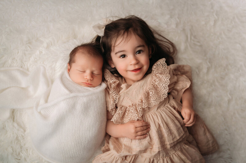Milford Newborn photographer captures newborn baby boy with his big sister. We document all of your baby's special moments from newborn to toddler.