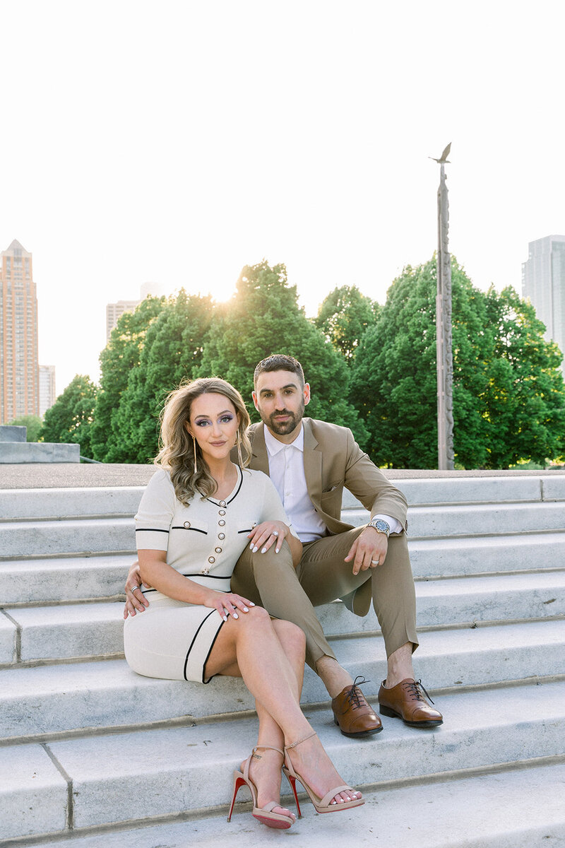 engaged couple sitting on chicago stairs
