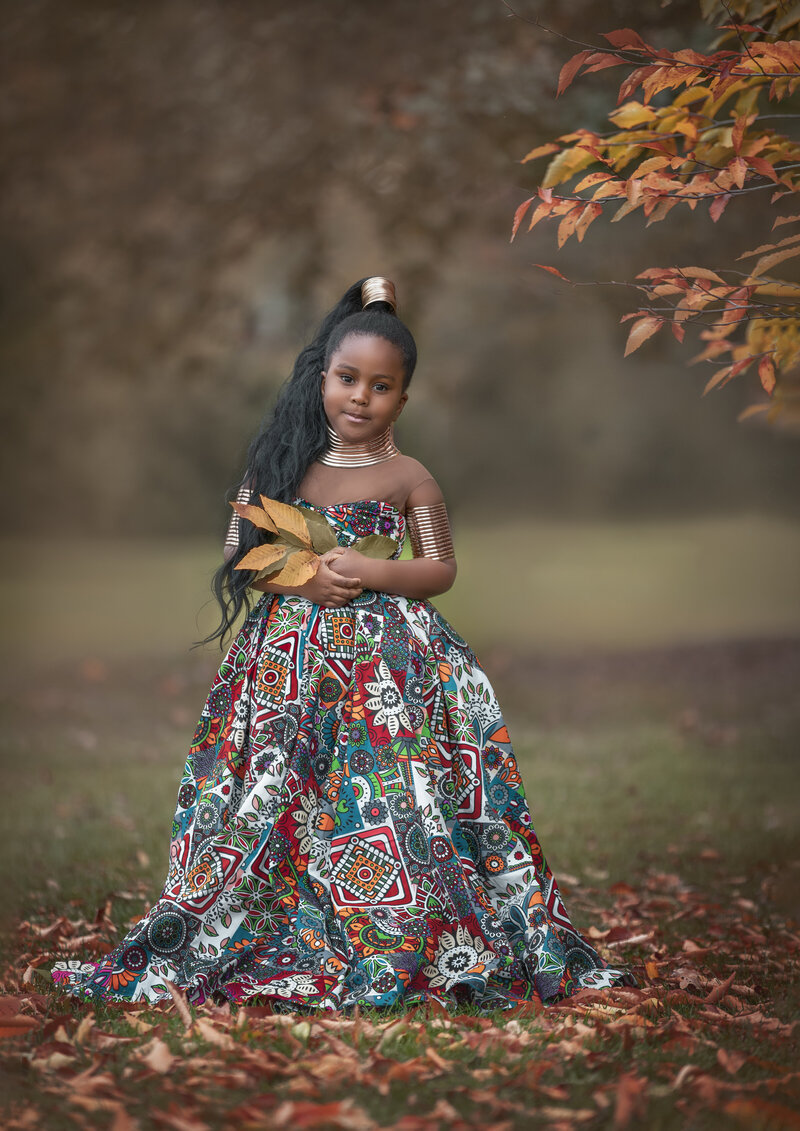 "Children dressed in stylish fall outfits, captured in a fashionable outdoor portrait session surrounded by autumn scenery in Ottawa."