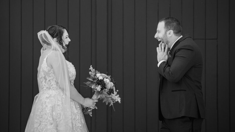 Bride and groom sharing a moment of complete joy during their first look at Phoenixville Foundry, captured in PJ style.