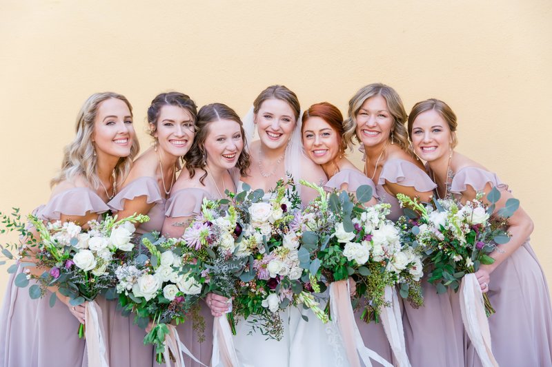 bride and bridesmaids pose together at the william aiken house in Charleston South Carolina wedding photographer