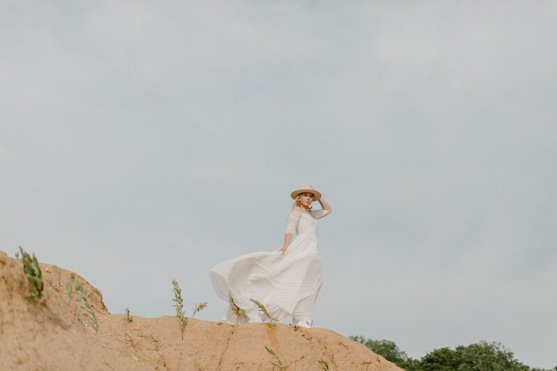 bride standing in mountain valley