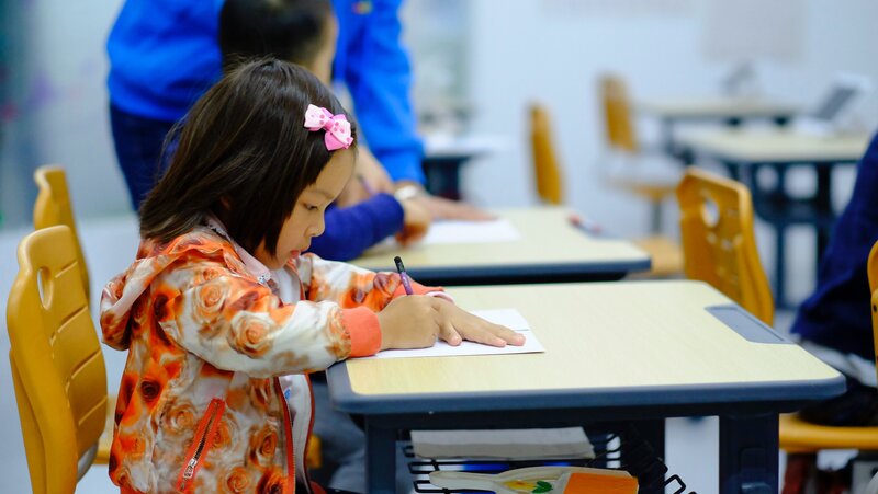 Student sitting at a table writing