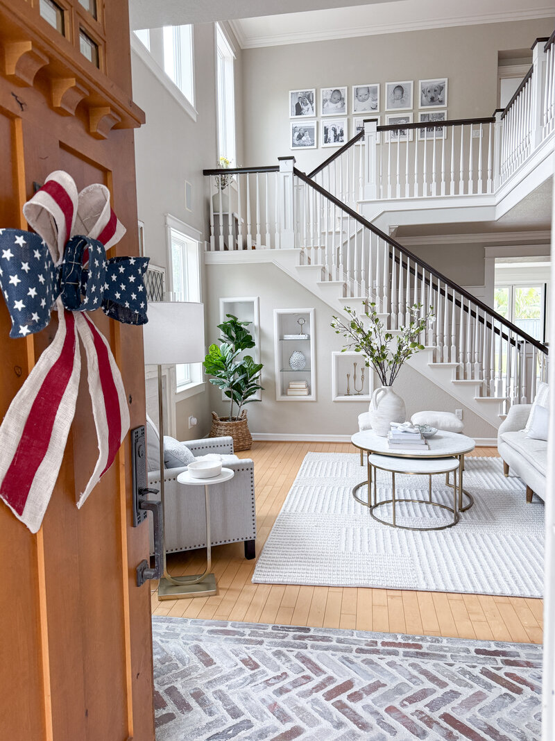 Living room view from front door with 4th of July bow on door 