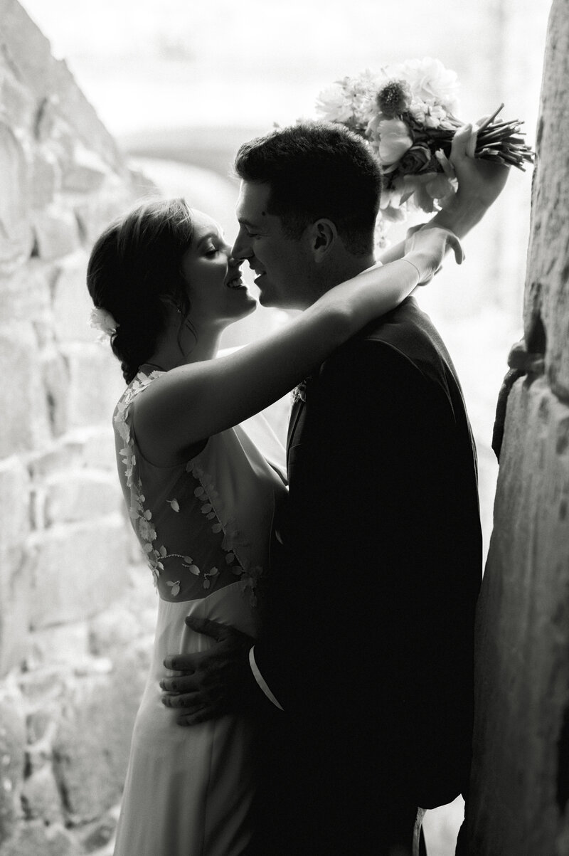 romantic black and white portrait of bride and groom kissing at ladybird johnson wildflower center by austin wedding photographer
