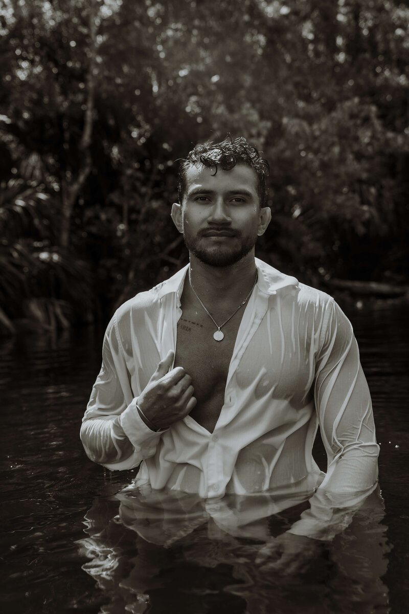 black and white photo of man coming out of water