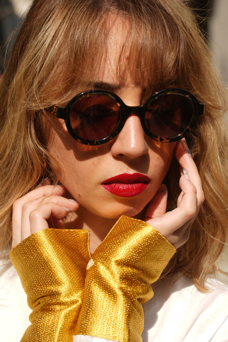 Woman wearing Xavier Derome sunglasses, featuring unique handcrafted eyewear available at Colaizzo Opticians in Queen Anne, Seattle