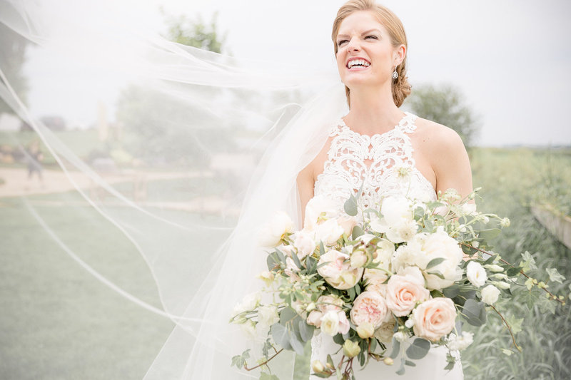 Bride with bridal bouquet and veil at Legacy Hill Farm in Welch Minnesota