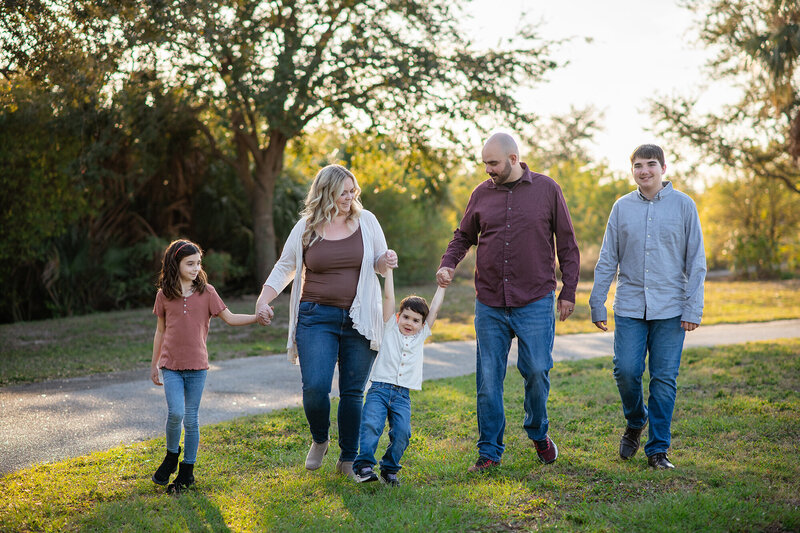 Family portraiture at Cypress Point park in Tampa, FL showing playing with family during golden hour 