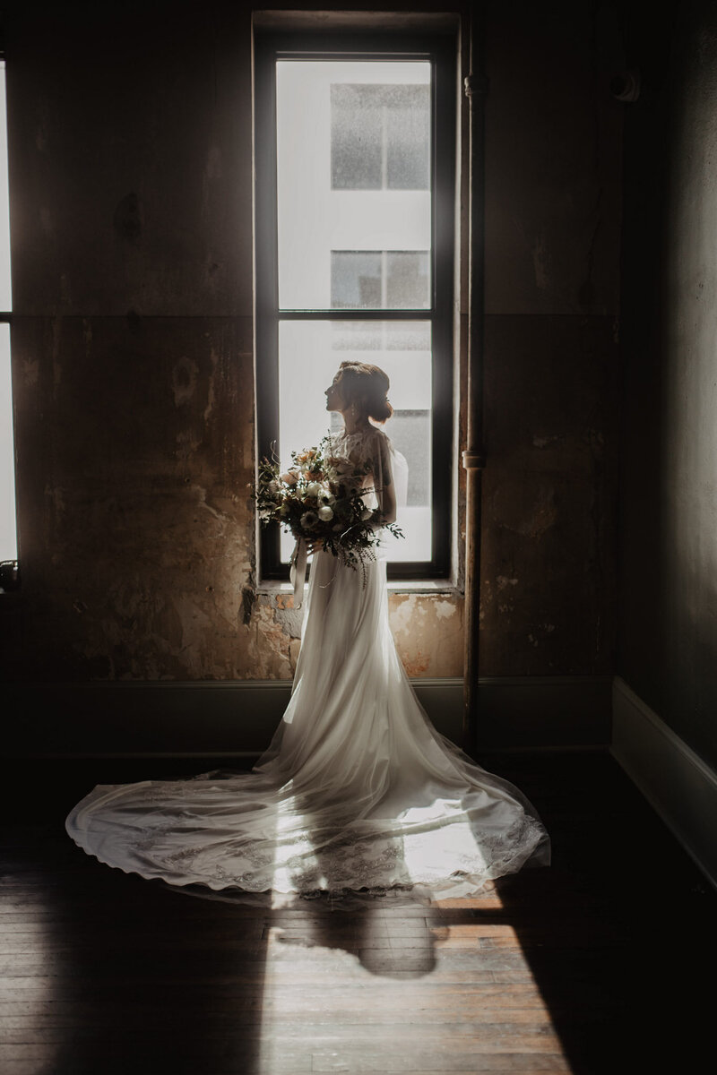 luxury bride standing in front of window