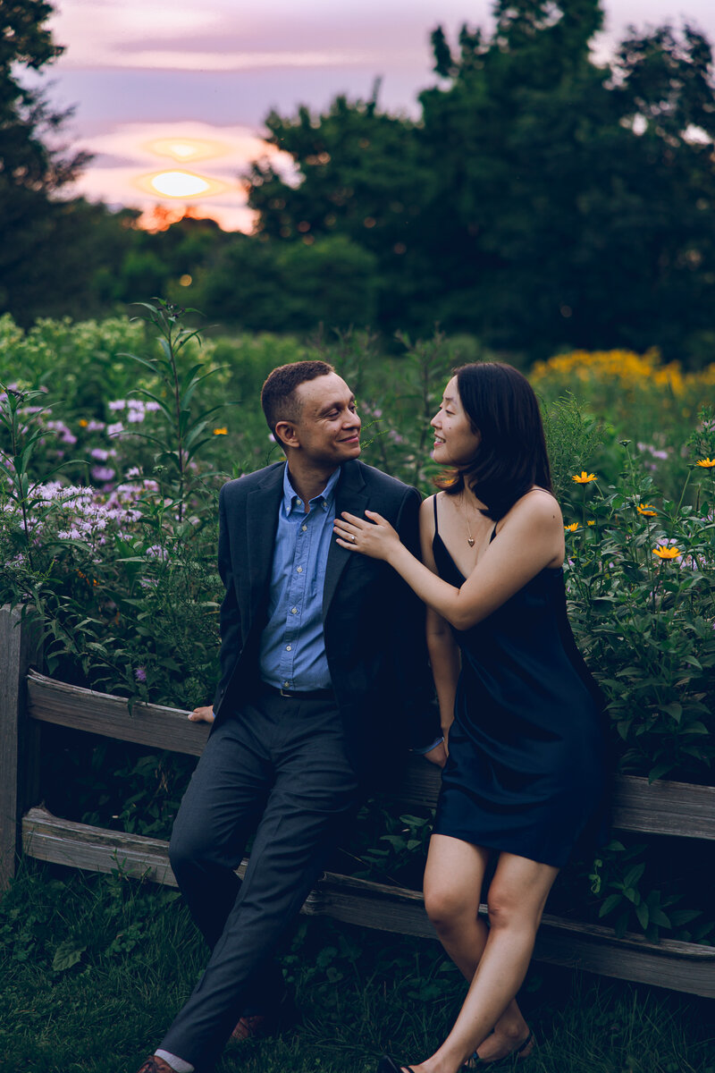 A couple holds hands in front of a mural in the Pilsen neighborhood of Chicago for the engagement session