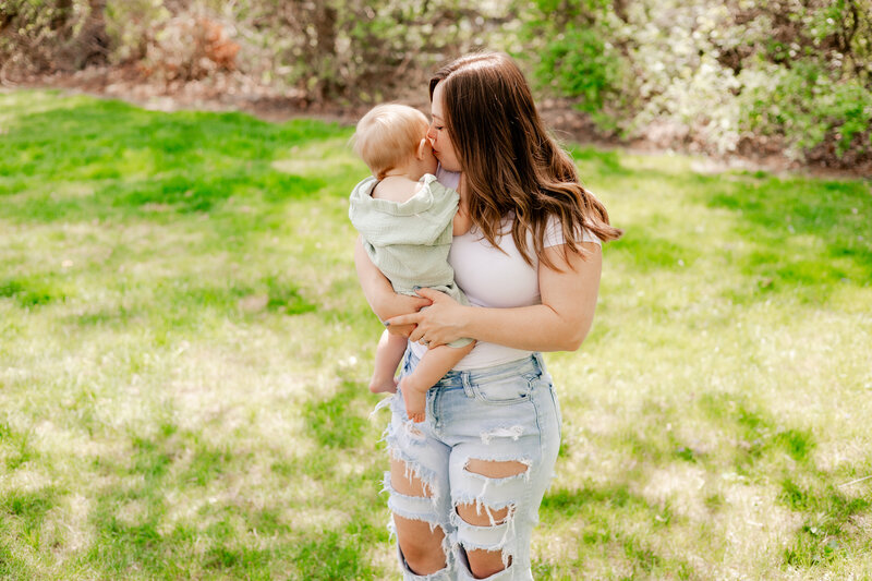 A mother and son session with mom kissing son on the cheek.