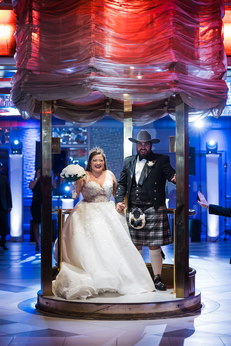 Bride and Groom appearing from lift in the reception room @Russo's on the Bay.