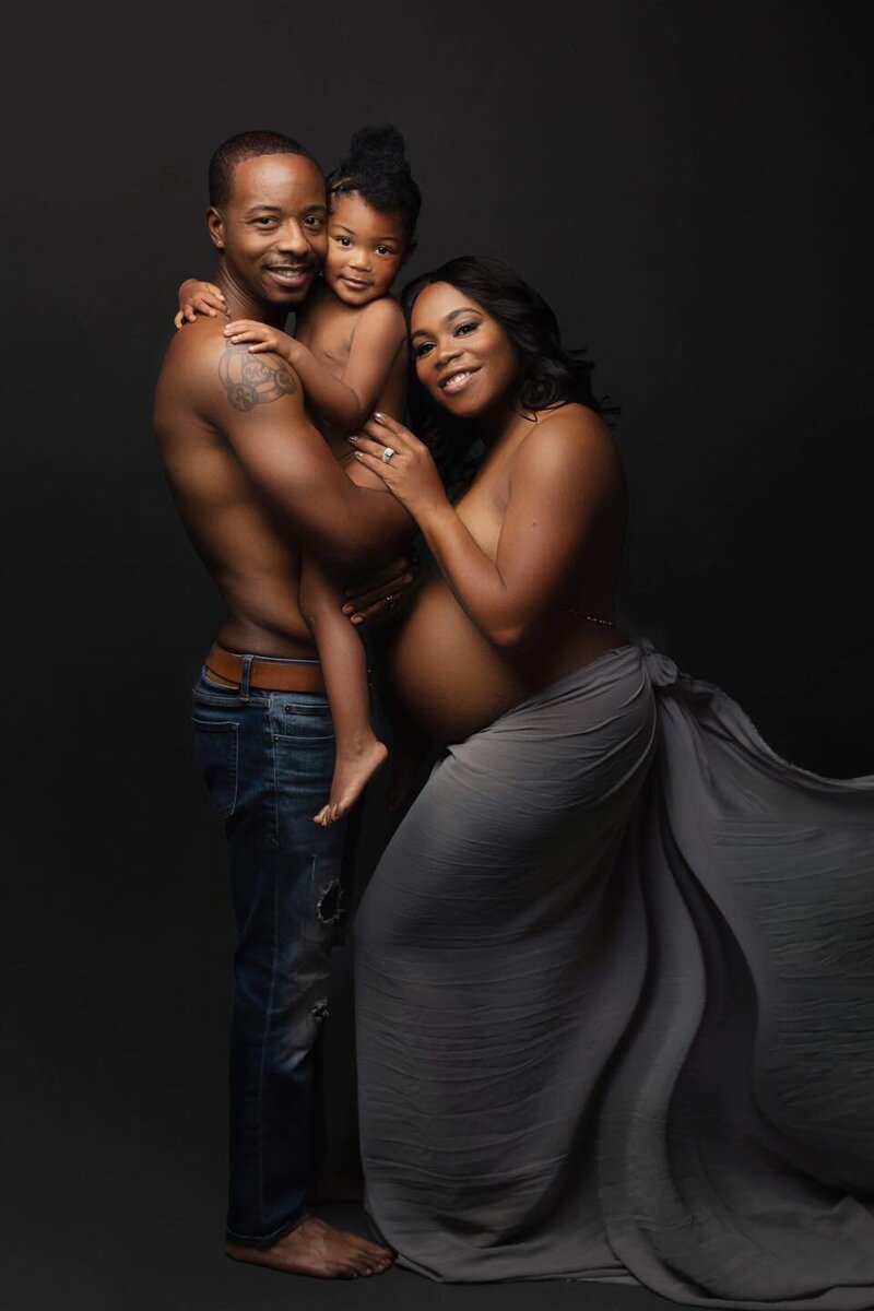 family posing for maternity session in phoenix maternity studio for editorial maternity session