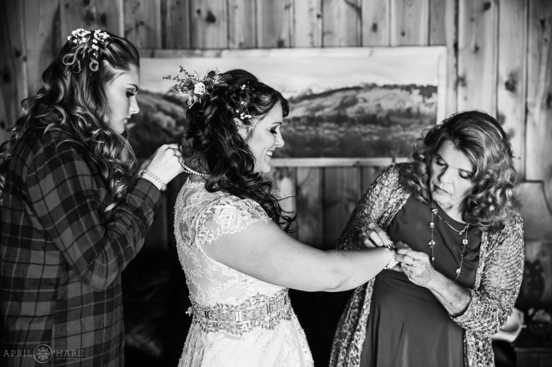 B&W photo of a bride getting ready for her wedding day at the Bear Creek Cabins in Evergreen, Colorado