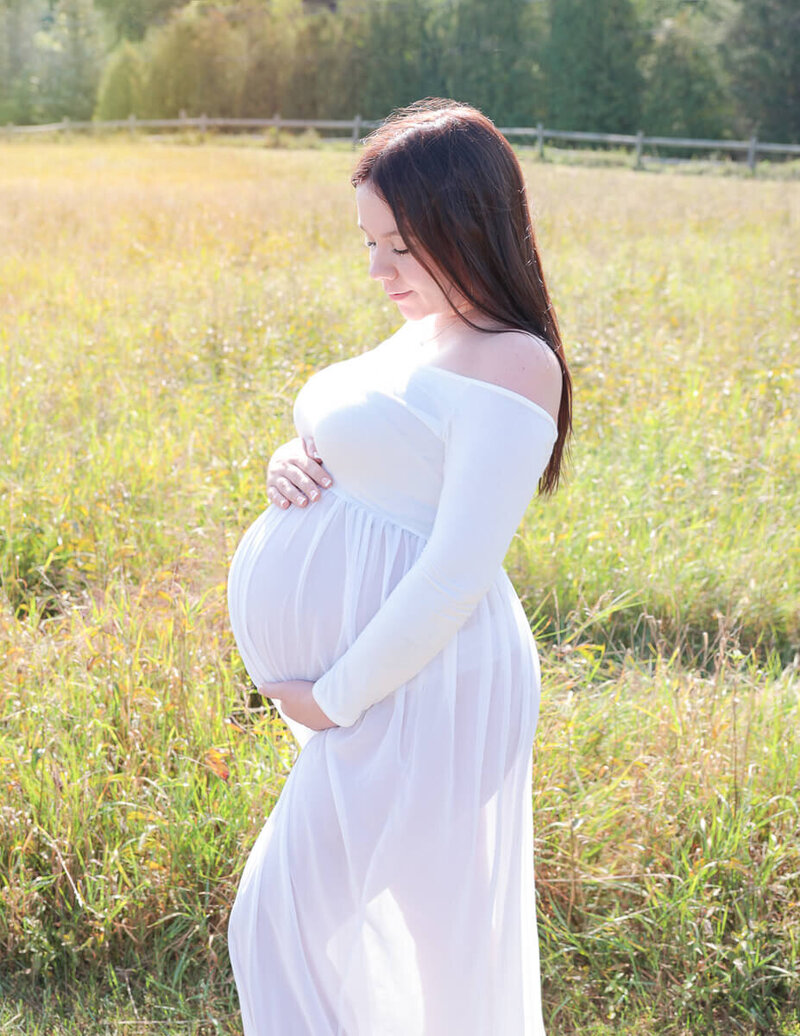 Posed maternity woman at our Rochester, Ny studio.