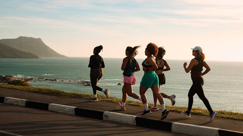 A group of women jogging on the road, focused on their fitness and sports nutrition.
