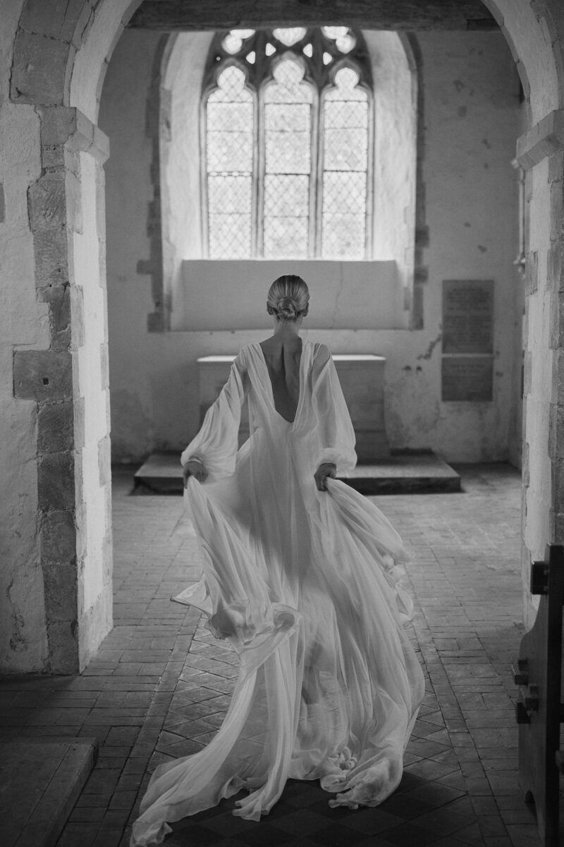Flowing wedding dress in silk by British designer