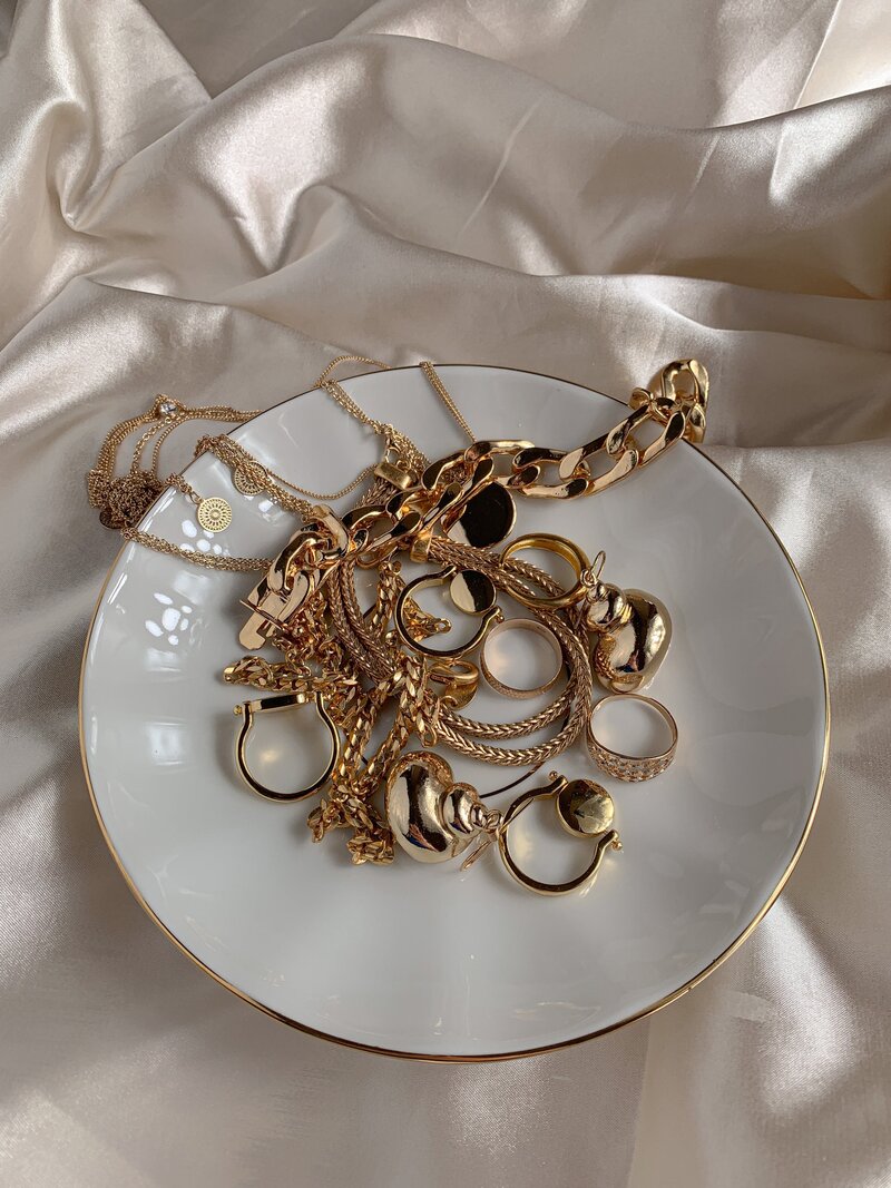 a plate of gold jewelry