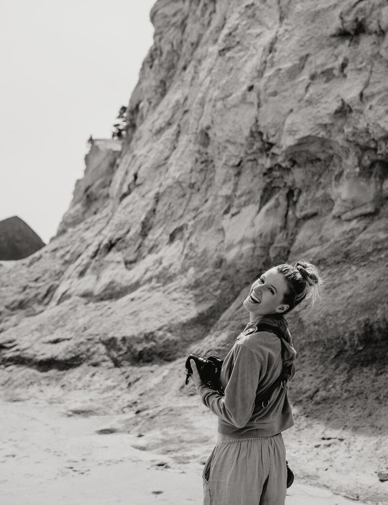 woman smiling holding camera