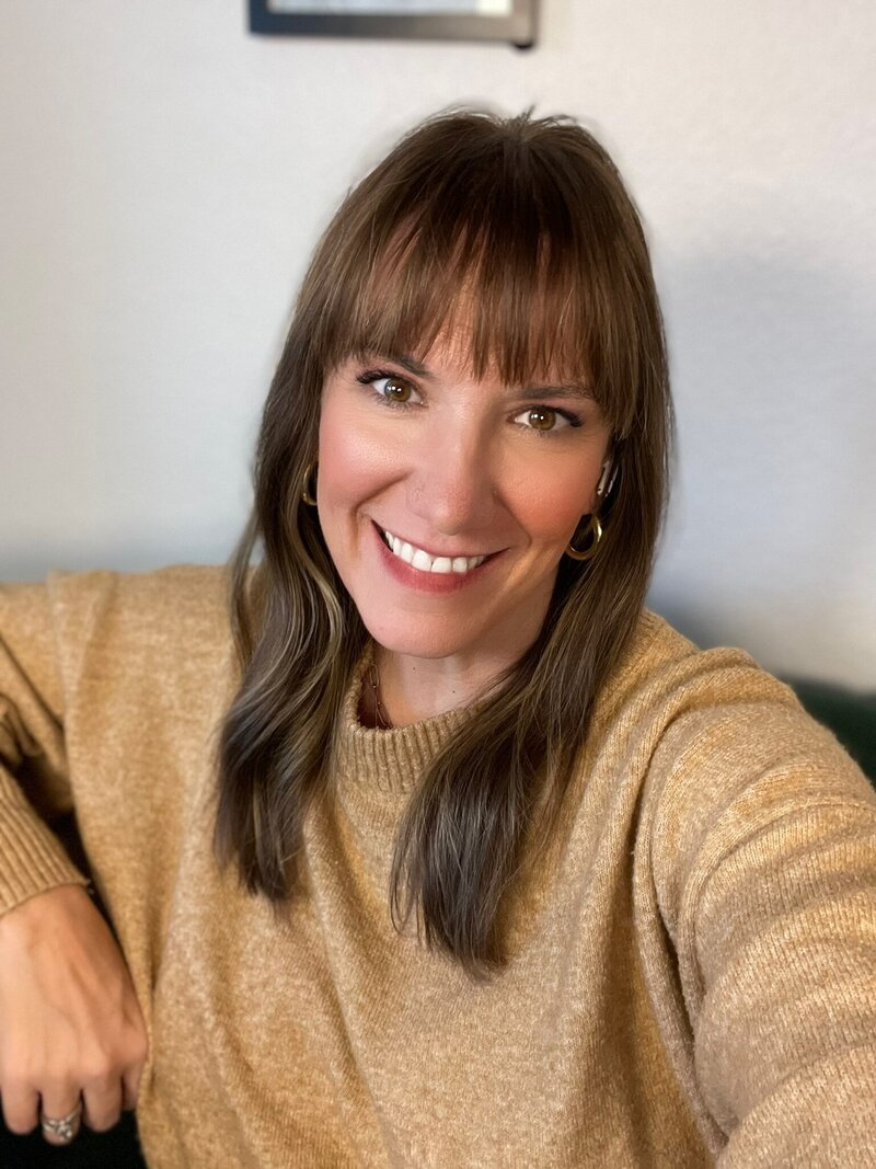 chasity campbell in brown sweater smiling at camera