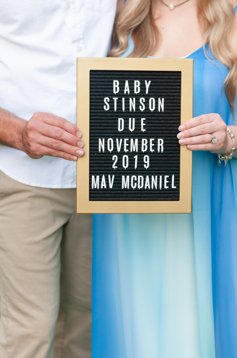 Kentucky Maternity Photography: Picture of a mother and father holding a pregnancy announcement sign.