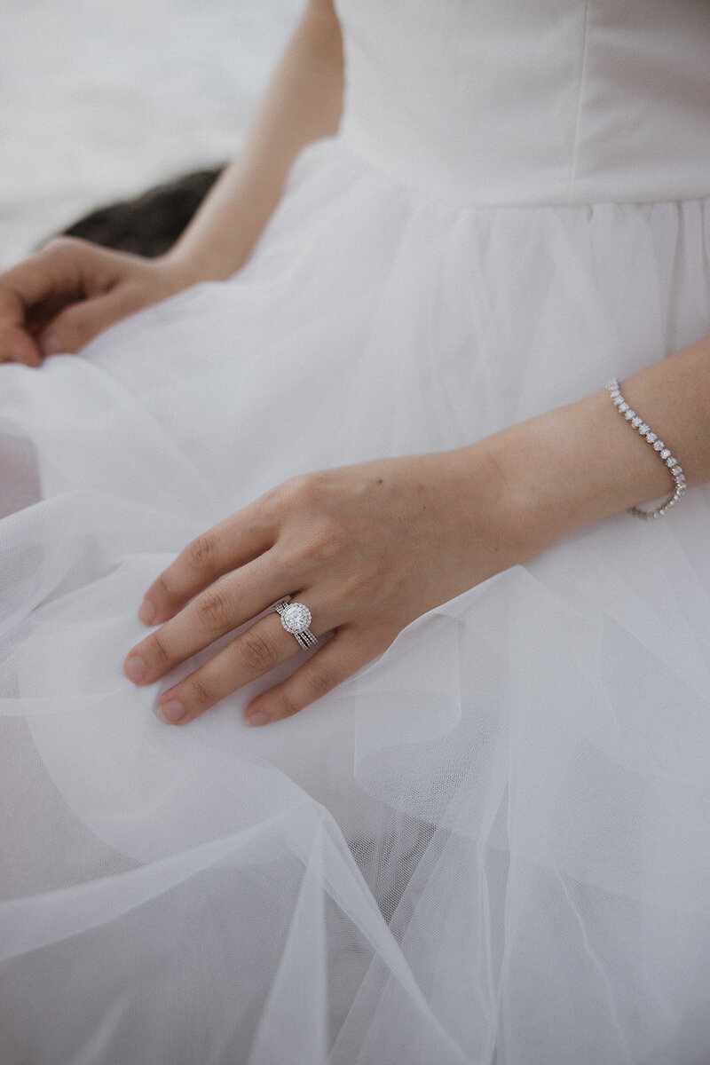 detail shot of wedding ring, and diamond bracelet that bride is wearing