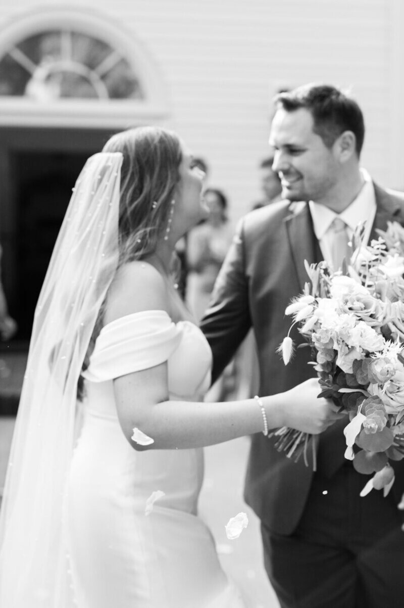 Wedding photography in Cincinnati at ceremony with bride holding a floral bouquet