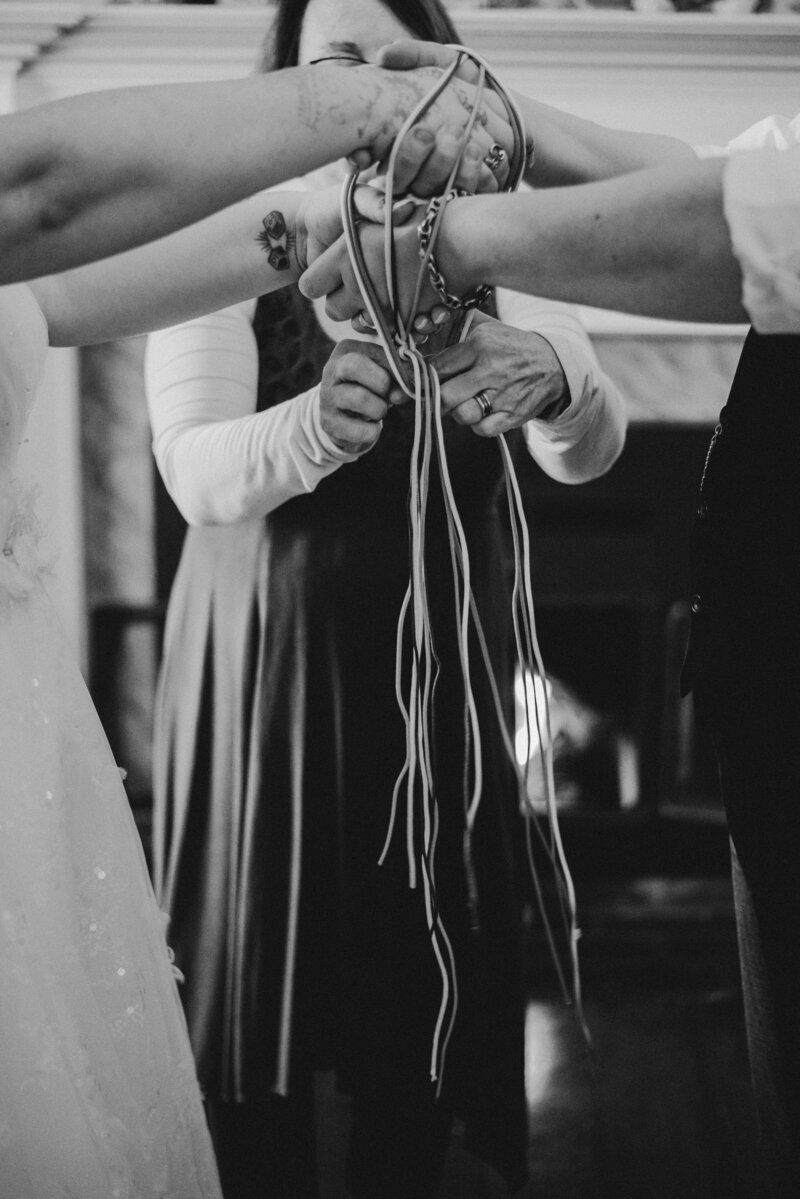 Couple participates in a handfasting ceremony at their wedding.