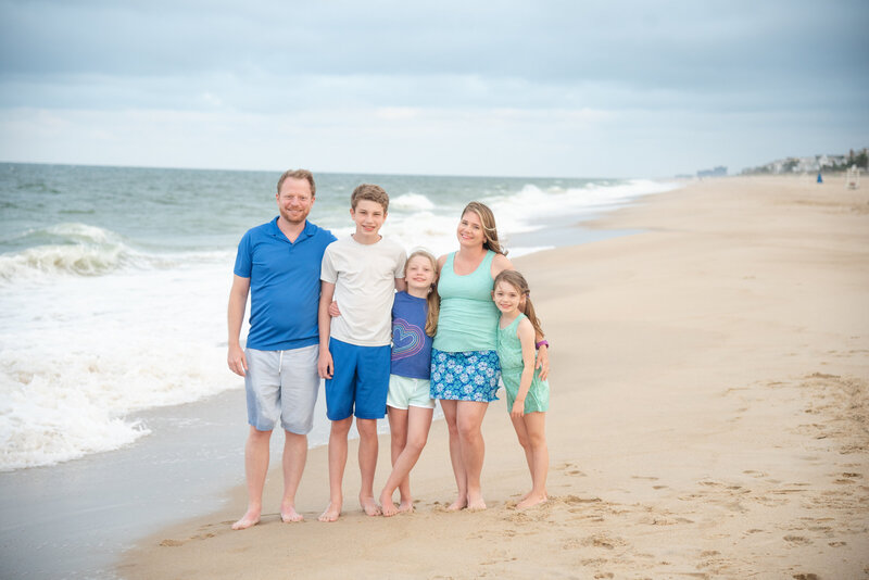 Beach Portrait of a Family of 5 all in Blues and teals. Photo taken by Dripping Springs Texas based Lydia Teague Photography.