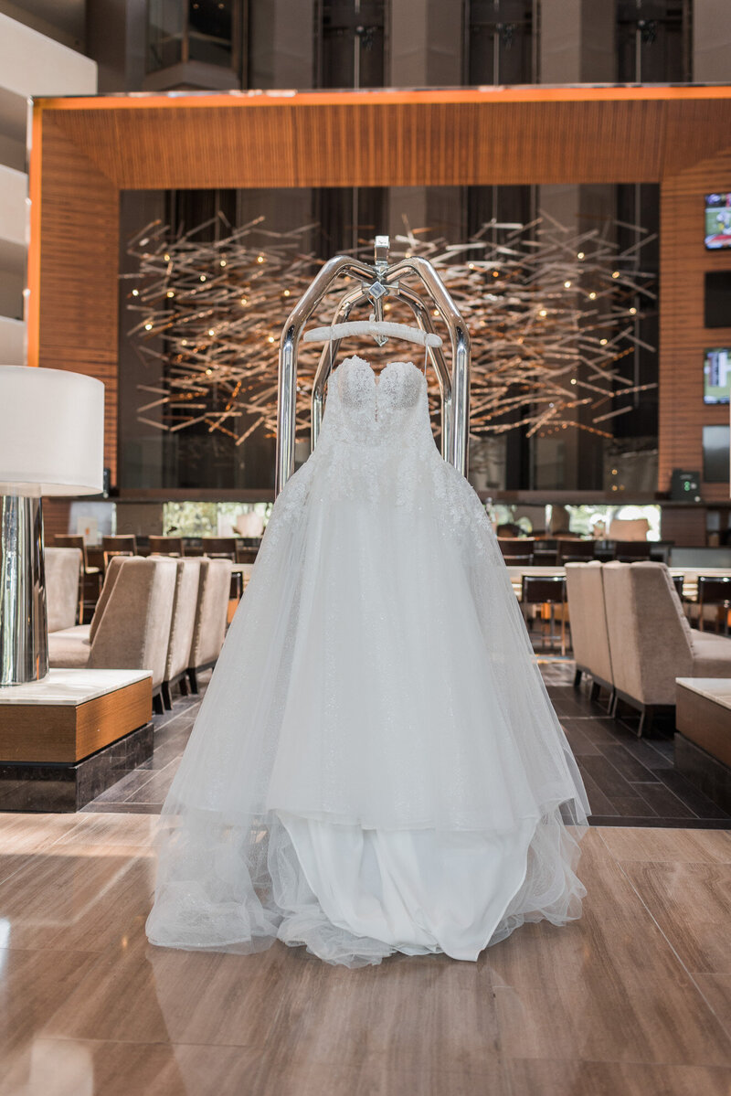 wedding dress hanging in hotel venue
