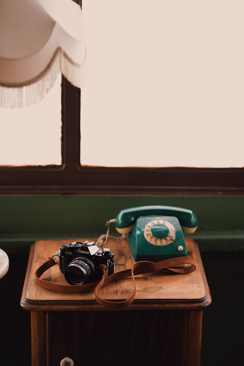 Old fashioned telephone and canon camera