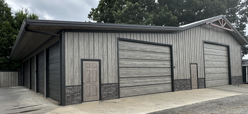 Gray metal shed showing steel siding with a wood look
