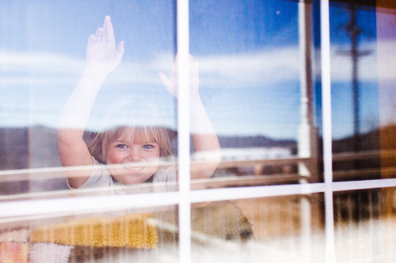 nederland girl looks out home window