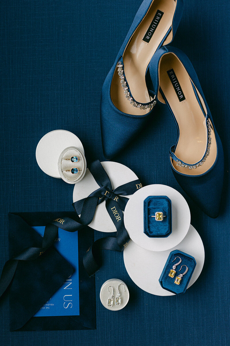 Soft blue linen flat lay mat styled with romantic paper goods and silk ribbon