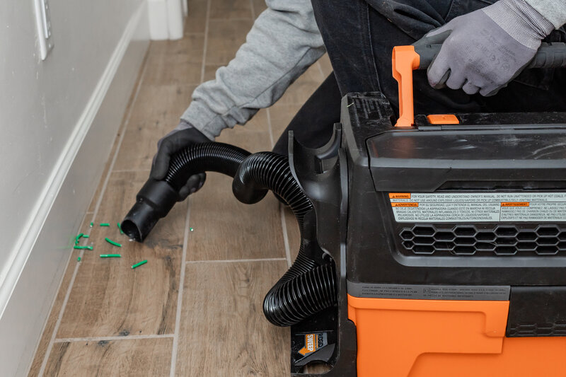 Electrician in Albuquerque cleaning floor after installation