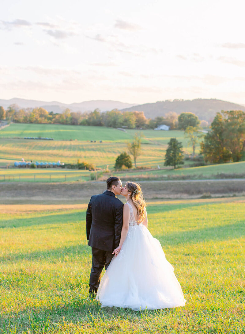 Bride and Groom kissing during sunset portraits in the mountains. Captured by Washington D.C. Wedding Photographer Bethany Aubre Photography.