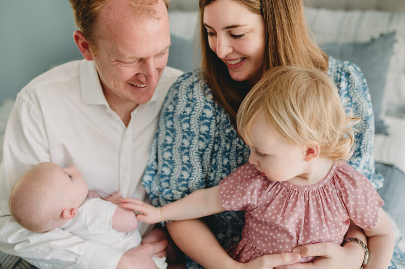 mom, dad, little girl and newborn