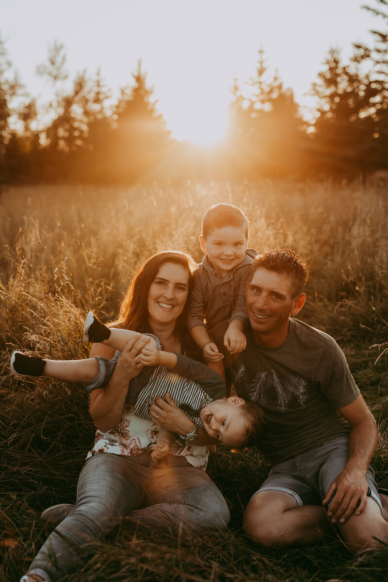 family-portrait-of-four-in-field