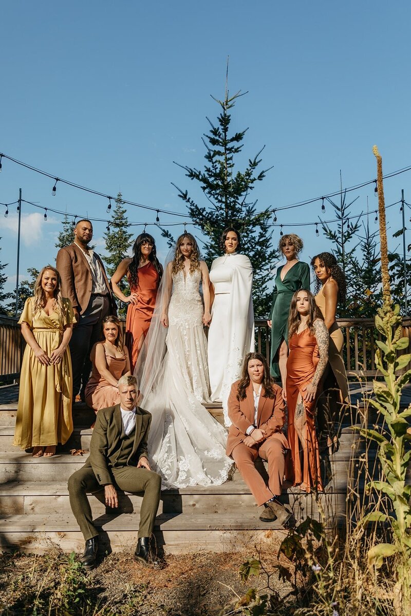 Full Bridal Party with Bride in Mixed Dresses and Suits in Fall Inspired Colors