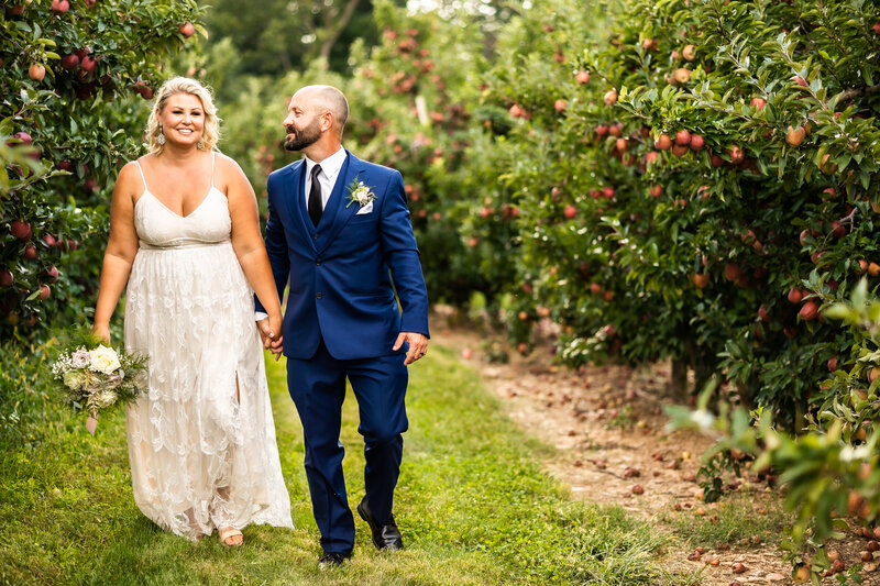 Bride and groom stroll through Browns Orchard, PA Wedding Photography