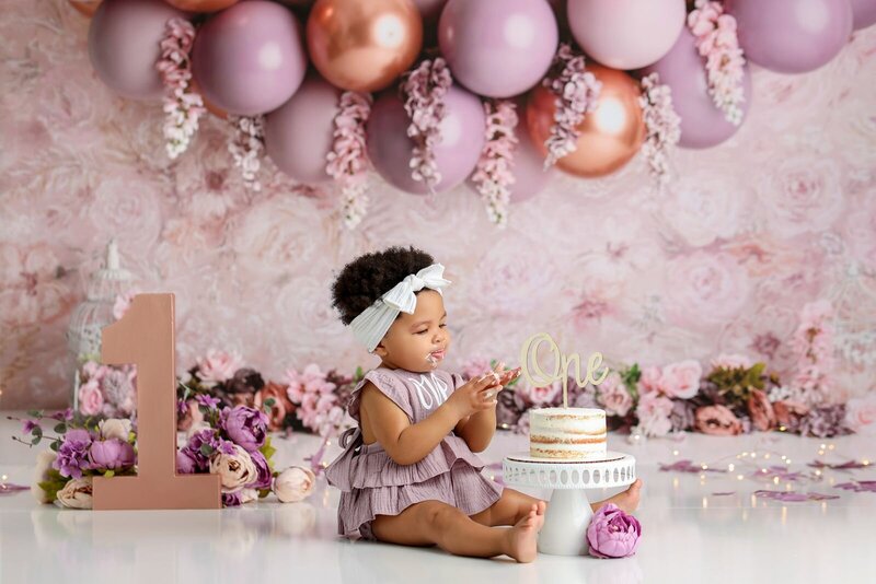 First birthday celebration with balloons and cake